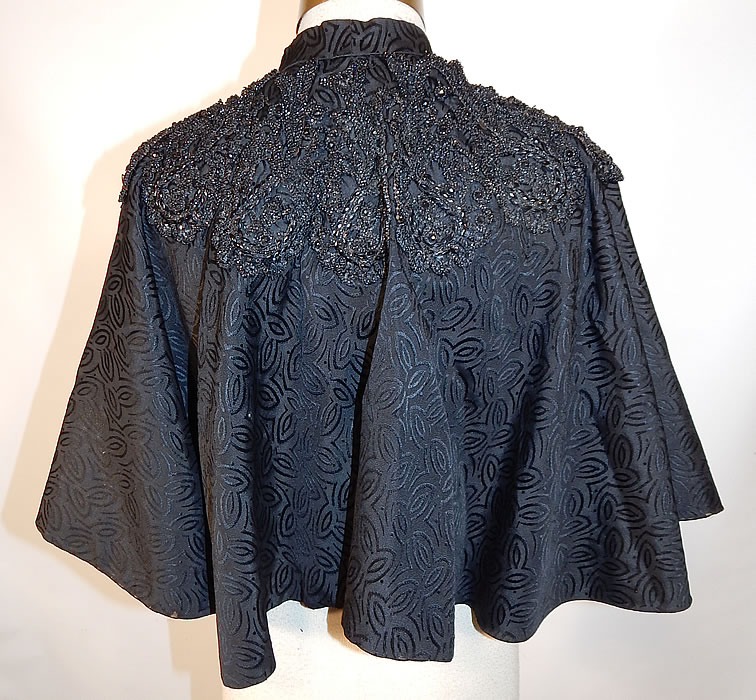 Victorian Black Silk Damask Brocade Jet Beaded Trim Mourning Cloak Cape
This stunning short cropped cloak cape capelet dolman mantle has a high neck band collar with hook closure, an attached beaded collar trim and is fully lined inside. 