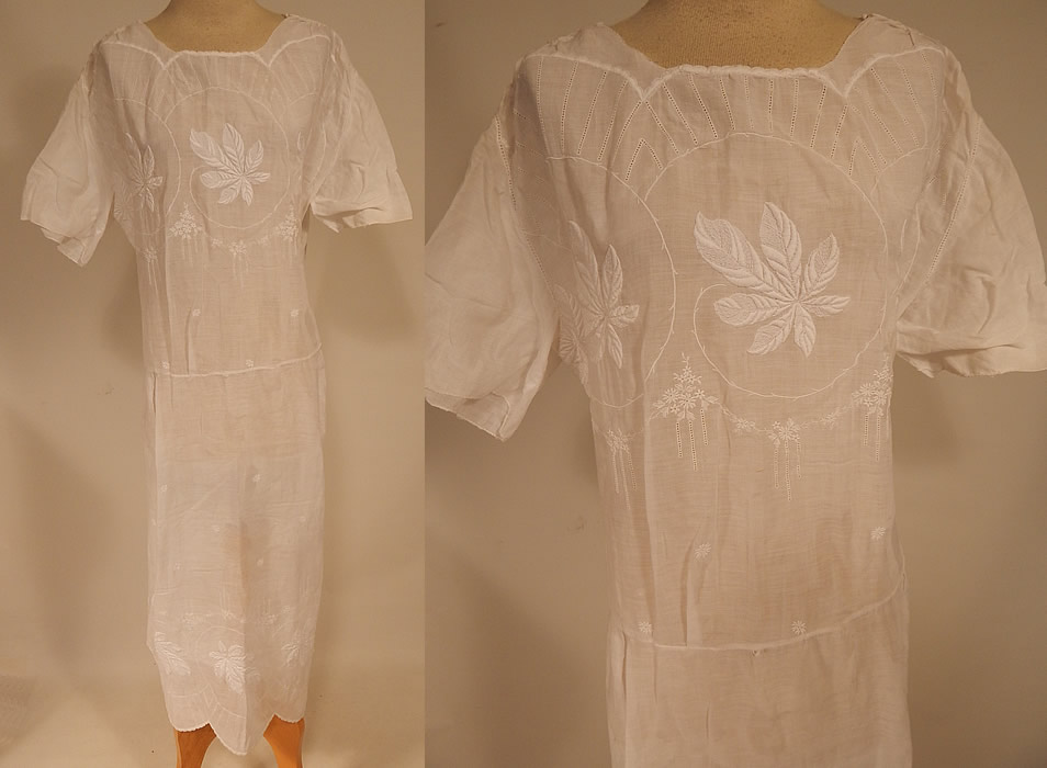 Vintage White Cotton Batiste Embroidered Forget-me-not Floral Leaf Drop Waist Dress
This vintage white cotton batiste embroidered forget-me-not floral leaf drop waist dress dates from the 1920s. It is made of a fine white cotton batiste fabric, with white raised padded satin stitch embroidery work of forget-me-not flowers, leaves and drawn cut work.