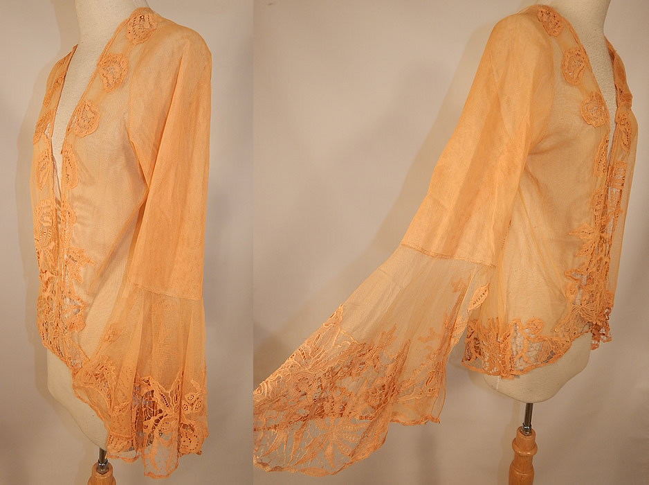 Vintage Antique Peach Ecru Net Battenburg Lace Coat Jacket Bell Sleeves
This lovely lace coat jacket has a loose fitting mid length style, open front, no closure, long full bell sleeves with wide flared open slit cuffs and is sheer, unlined.