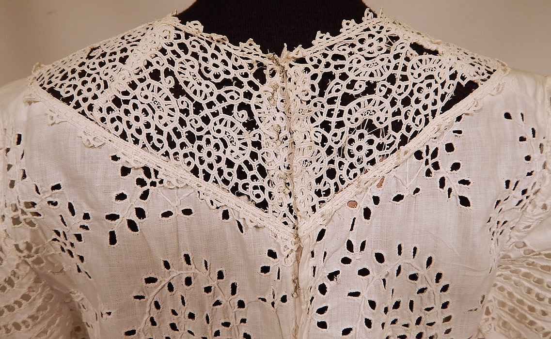 Victorian White Cotton Batiste Broderie Anglaise Eyelet Embroidery Cutwork Lace Dress
The dress measures 52 inches long, with a 26 inch waist and 36 inch bust. It is in good as-is condition, having been altered with an added bottom skirt hemline trim, patched, reinforced added skirt panel on back to be made larger and several small breaks in the lace collar yoke (see close-ups). 