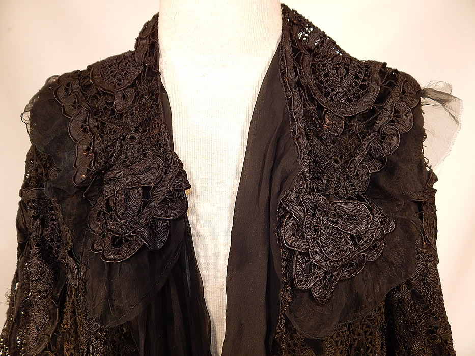 Edwardian Black Silk Battenburg Tape Lace Shawl Collar Long Coat Jacket
This lovely lace loose fitting coat jacket is a long length, with long full sleeves, a shawl collar, black silk chiffon lining inside, an attached neck scarf tie hanging down the front and open an front with no closure. The coat measures 42 inches long, with 46 inch hips, a 46 inch waist, 44 inch bust, 17 inch back and 25 inch long sleeves.