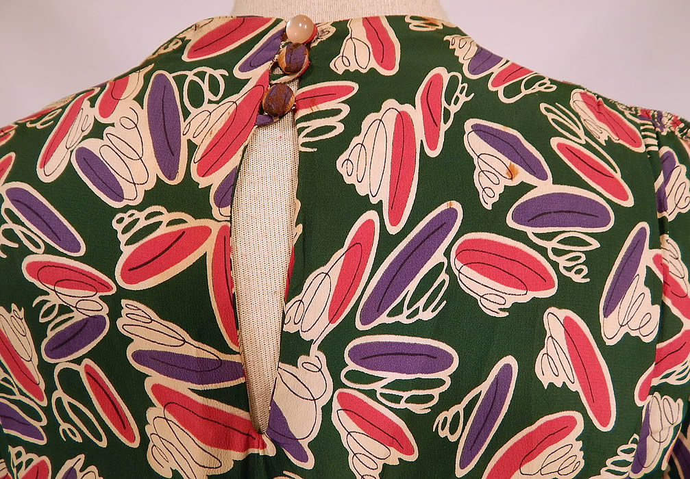 Vintage Green Pink Purple Coil Springs Abstract Novelty Print Rayon Peplum Dress
The dress measures 45 inches long, with 38 inch hips, a 28 inch waist and 38 inch bust. It is in good condition, has not been cleaned, with some discoloration on the top neckline, small faint age spot stains scattered and the top button on back has been replaced. This is truly a wonderful piece of wearable art!