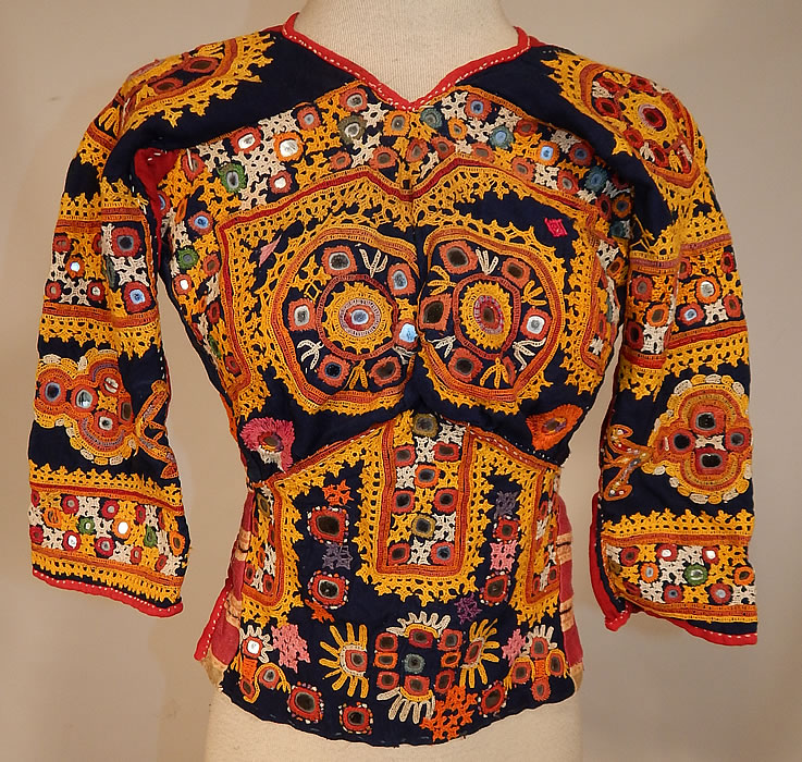 Vintage Antique Indian Gujarati Kutch Work Embroidered Mirror Choli Boho Blouse Top
This vintage antique Indian Gujarati kutch work colorful embroidered mirror choli boho blouse top dates from the early 1900s. It is made a hand dyed indigo blue and red linen fabric with vibrant colorful decorative crewel chain stitch kutch work embroidery done in the tribal folk patterns from Gujarati, Rajasthan India and Sindh Pakistan.