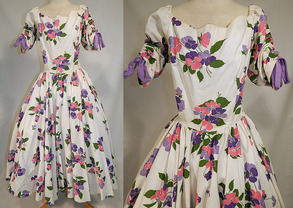 Vintage White Cotton Pique Pansy Print Full Circle Skirt Dress
This vintage white cotton pique pansy print full circle skirt dress dates from the 1950s. It is made of a white cotton pique textured waffle ribbed fabric, with shades of pink, purple and green leaf floral pansy print design.