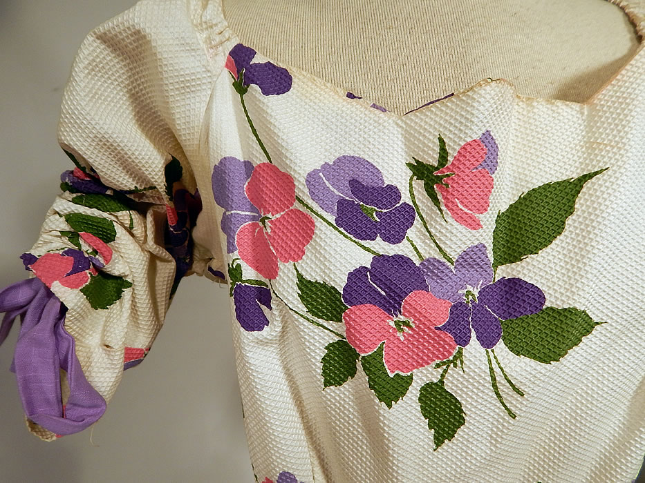 Vintage White Cotton Pique Pansy Print Full Circle Skirt Dress
This pretty party summer dress has adjustable drawstring purple straps inside the short sleeves with gathering along the shoulders, a scalloped edge neckline, very full circle skirt, side zipper closure and is unlined.