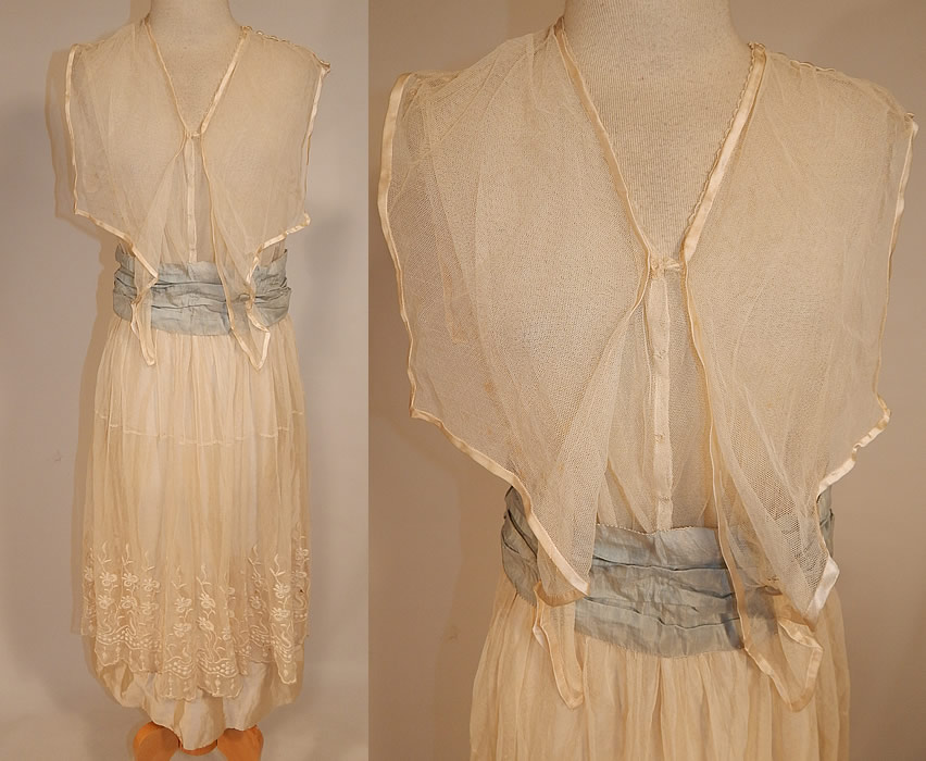 Edwardian White Net Embroidered Lace Sailor Middy Top Blue Sash Belted Dress
This vintage Edwardian era white net embroidered lace sailor middy top blue sash belted dress dates from 1915. It is made of a sheer fine white tulle net, with raised padded satin stitch embroidery work done in a floral pattern design along the bottom skirt.