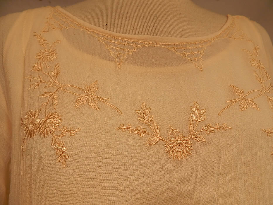 Vintage April Cornell Cream Embroidered Floral Butterfly 1920s Style Wedding Dress
This beautiful bridal 1920s inspired wedding dress has a loose fitting drop waist style, short sleeves, streamer strip panels tulle net layered skirt and comes with the original cream rayon slip dress underneath. 