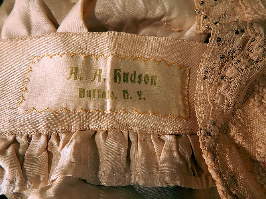 Edwardian Belle Epoque Cream Embroidered Net Lace Beaded Rosette Dress
There is an "A. A. Hudson Buffalo, N.Y." label sewn inside the waistband.