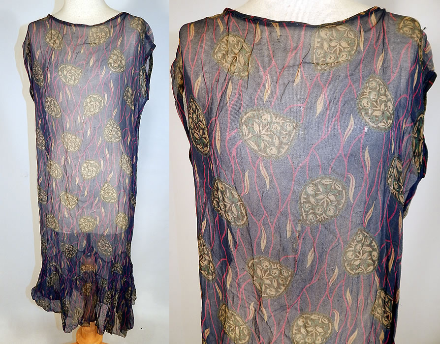 Vintage Art Deco Navy Blue Green Leaf Abstract Print Silk Chiffon Drop Waist Dress
This vintage Art Deco navy blue green leaf abstract print silk chiffon drop waist dress dates from the 1920s. It is made of a navy blue background, with pink and green abstract floral leaf print designs on the sheer silk chiffon fabric.