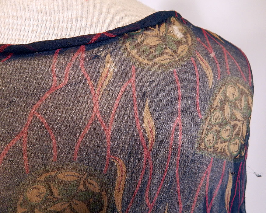Vintage Art Deco Navy Blue Green Leaf Abstract Print Silk Chiffon Drop Waist Dress
The dress measures 41 inches long, with 40 inch hips, a 40 inch waist and 40 inch bust. The dress is in fair as-is condition with several small frayed holes scattered (see close-up). This is truly a wonderful piece of wearable art which would be great for design!