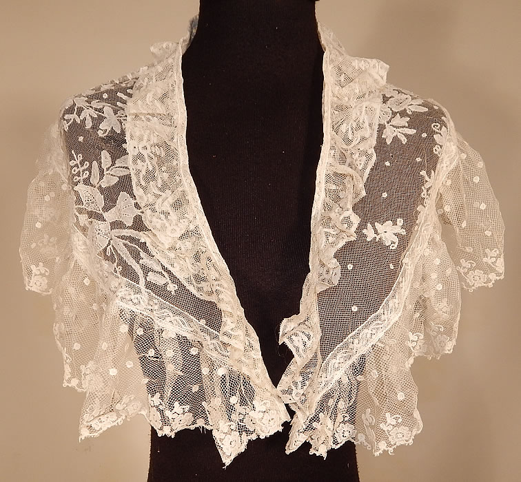 Victorian White Needlepoint Applique Lace Fichu Kerchief Scarf Shawl Collar Cape Pelerine
This Victorian era antique white needlepoint appliqué lace fichu kerchief scarf shawl collar cape pelerine dates from the late 19th century. It is made of a sheer white needlepoint appliqué lace done on machine made net in a floral leaf, polka dot design.