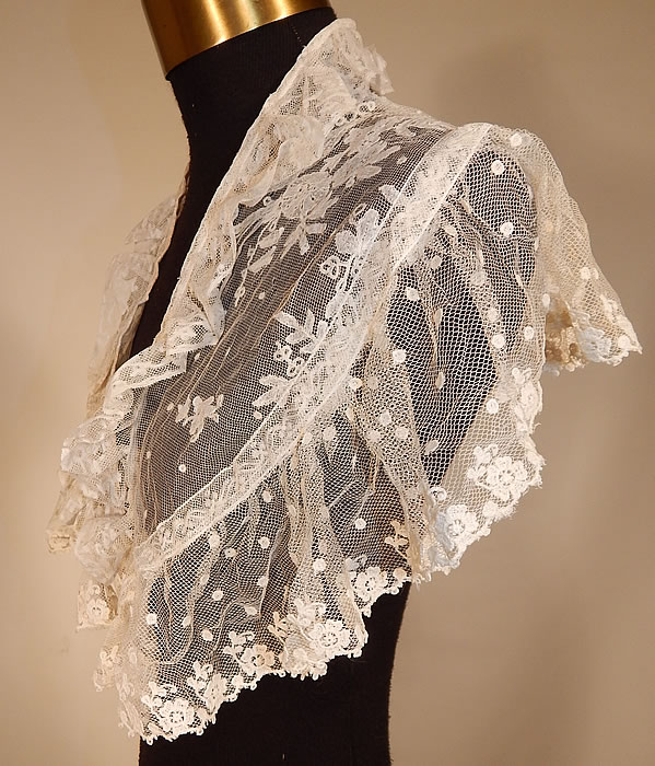 Victorian White Needlepoint Applique Lace Fichu Kerchief Scarf Shawl Collar Cape Pelerine
This lovely lace fichu kerchief scarf shawl collar capelet pelerine has a triangle shape, with scalloped ruffle trim bottom edging, fold over ruffle neckline, an open front with no closure and is sheer, unlined.