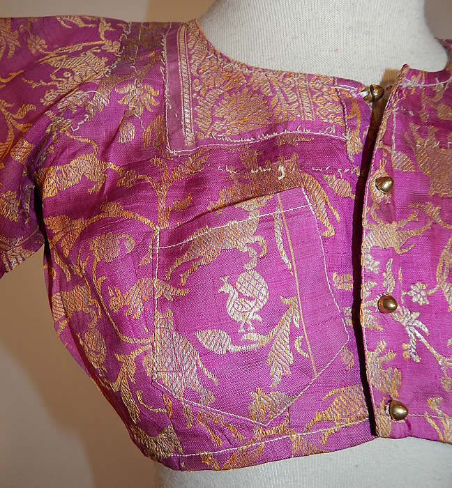 Vintage 19th Century Indian Purple Silk Sari Gold Lamé Lame Choli Crop Top Blouse
This stunning traditional handmade short cropped choli boho blouse top has a fitted style, with short sleeves, a front breast pocket, newly replaced gold plastic buttons for closure down the front and is partially lined in a linen fabric inside. 