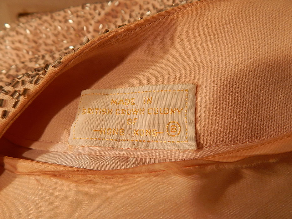 Vintage Hong Kong Custom Made Blush Pink Silk Silver Beaded Evening Gown
There is a "Made in British Colony of Hong Kong" label sewn inside. The dress measures 58 inches long, with a 24 inch waist and 34 inch bust. It is in good condition, but has not been cleaned, with some faint makeup stains inside the neckline and a few missing beads on the shoulders. This is truly a wonderful piece of custom made wearable beaded art!