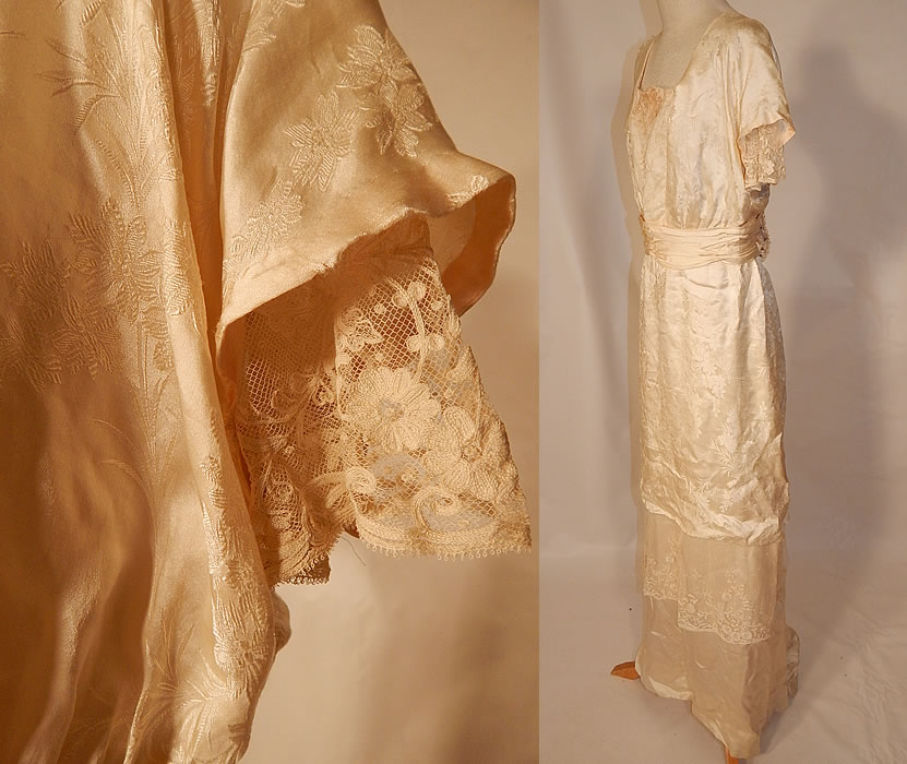 Edwardian Titanic Silk Damask Brocade Tambour Embroidery Lace Wedding Gown Dress
This beautiful bridal wedding dress has a long floor length layered tiered skirt with slight back train, squared necklines, layered short sleeves, a pleated belted sash waist, hook closures on the back and is fully lined.
