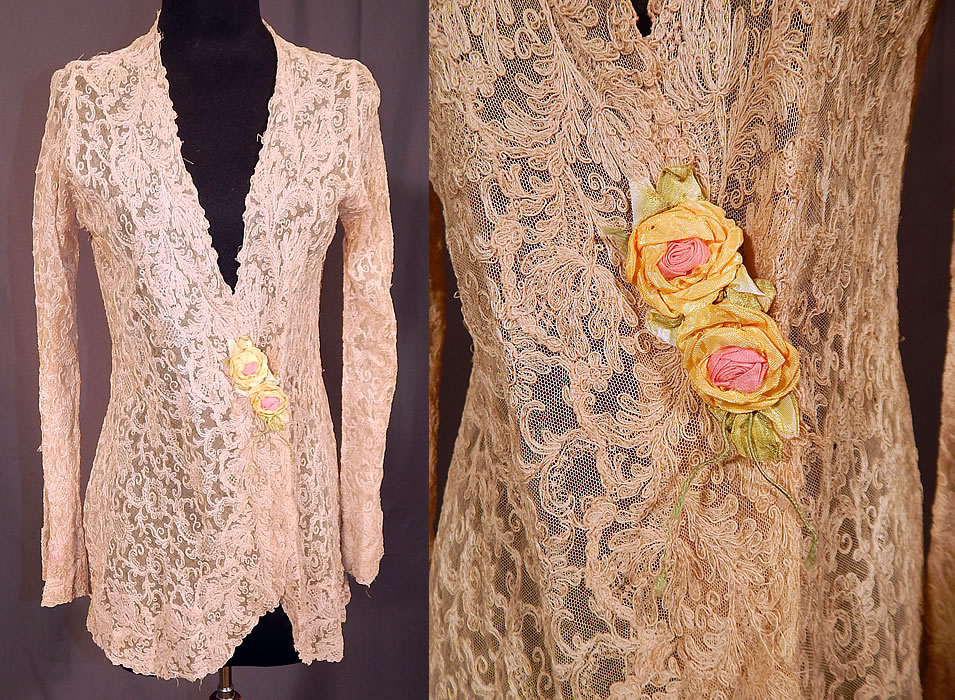 Vintage Silk Ribbon Rosette Trim Cream Tambour Embroidery Net Lace Jacket
This vintage silk ribbon rosette trim cream tambour embroidery net lace jacket dates from the 1920s. It is made of an off white ecru cream color sheer tambour embroidery net lace fabric, with a spiral, scrolling, floral design and yellow, pink silk ribbon rosette trim. 