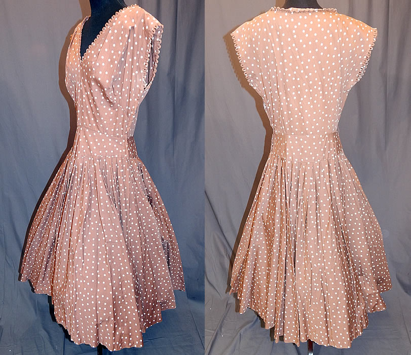 Vintage R & K Original Brown White Polka Dot Print Cotton Circle Skirt Dress
This "I Love Lucy" inspired dress has a fit and flare style, with a full circle skirt, scalloped loop trim edging along the V neckline and sleeveless arm holes, a side zipper closure and is unlined.