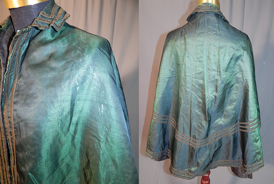 Victorian Civil War Era Iridescent Green Silk Batwing Dolman Mantle Cloak Cape
This magnificent mantle dolman style cloak cape has a fold over collar, full flared bottom back skirt, batwing scalloped sides, longer open front with no closure and is fully lined. The cape measures 35 inches long in the front, 28 inches long in the back and is 40 inches wide at the bottom. 