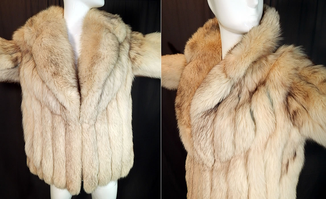 Vintage The Evans Collection Amber Fox Fur Shawl Collar Winter Coat Jacket
This fabulous fur winter coat jacket has a short mid hip length, with a loose fitting boxy style, large rolled shawl collar, long full sleeves, a single furrier hook closure at the chest and is fully lined in a cream silk satin fabric.