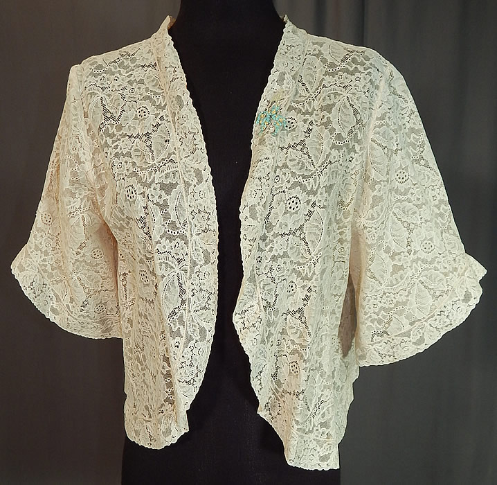 Vintage Forget Me Not Rosette Trim Cream Lace Cropped Bolero Boudoir Bed Jacket
This vintage forget me not rosette trim cream lace cropped bolero boudoir bed jacket dates from the 1930s.