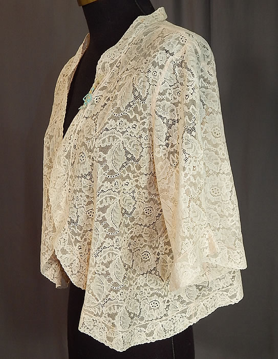 Vintage Forget Me Not Rosette Trim Cream Lace Cropped Bolero Boudoir Bed Jacket
This lovely lace lingerie boudoir bed jacket has a short cropped bolero style, with a cut away open front, no closure, full short sleeves and is sheer, unlined.