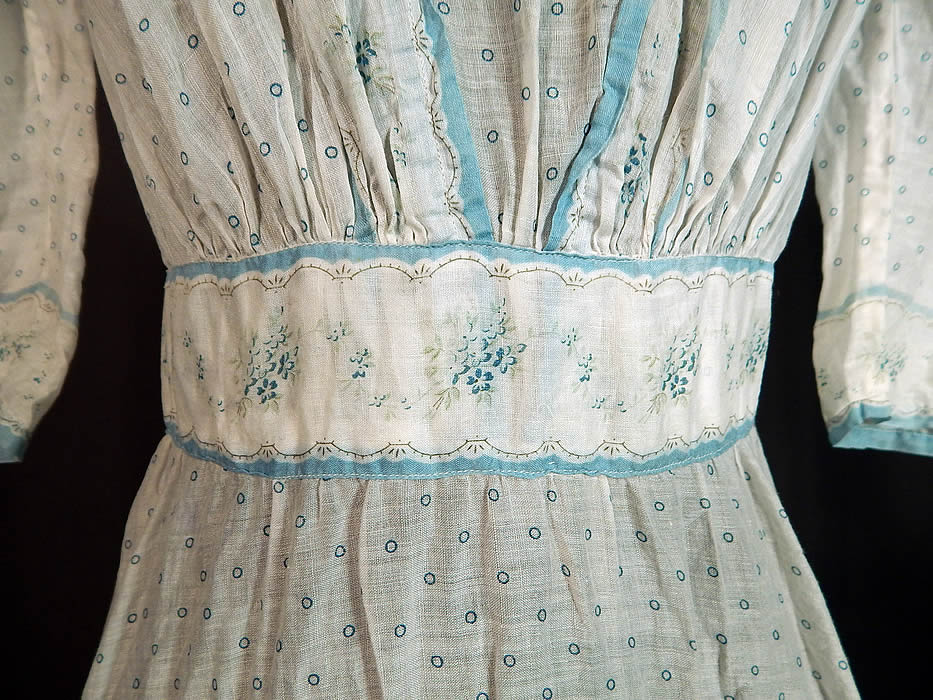 Victorian Blue & White Cotton Batiste Polka Dot Floral Calico Print Girls Dress
This girls pretty party dress has a short mid length skirt, with 3/4 length sleeves, a fitted floral print waistband, Swiss dot white net lace trim neckline, pleated accents, button closures down the back and is unlined.