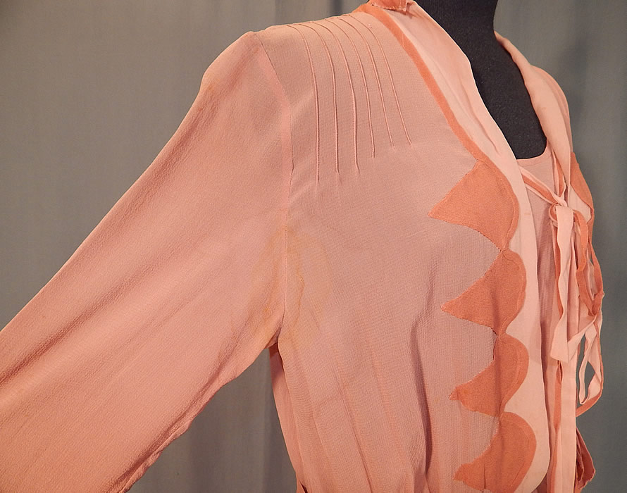 Vintage Art Deco Old Rose Pink Silk Crepe de Chine Appliqu&eacute;d Belted Bias Cut Dress
The dress measures 52 inches long, with 38 inch hips, a 32 inch waist, 38 inch bust and 20 inch long sleeves. It is in fair as-is condition, with several faint water spot stains, underarm stains, some frayed splits on the silk appliqu&eacute; sleeve cuff trim (see close-ups). This is truly a wonderful piece of Art Deco textile art which would be great for design and pattern!