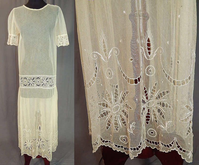 Vintage Cream Sheer Tulle Net Eyelet Cutwork Lace Floral Drop Waist Dress
This vintage cream sheer tulle net eyelet cutwork lace floral drop waist dress dates from the 1920s. It is made of an off white cream color sheer tulle net lace fabric with eyelet cutwork done in a floral garland design along the bottom skirt scalloped hem, front waistband and sleeve cuffs.