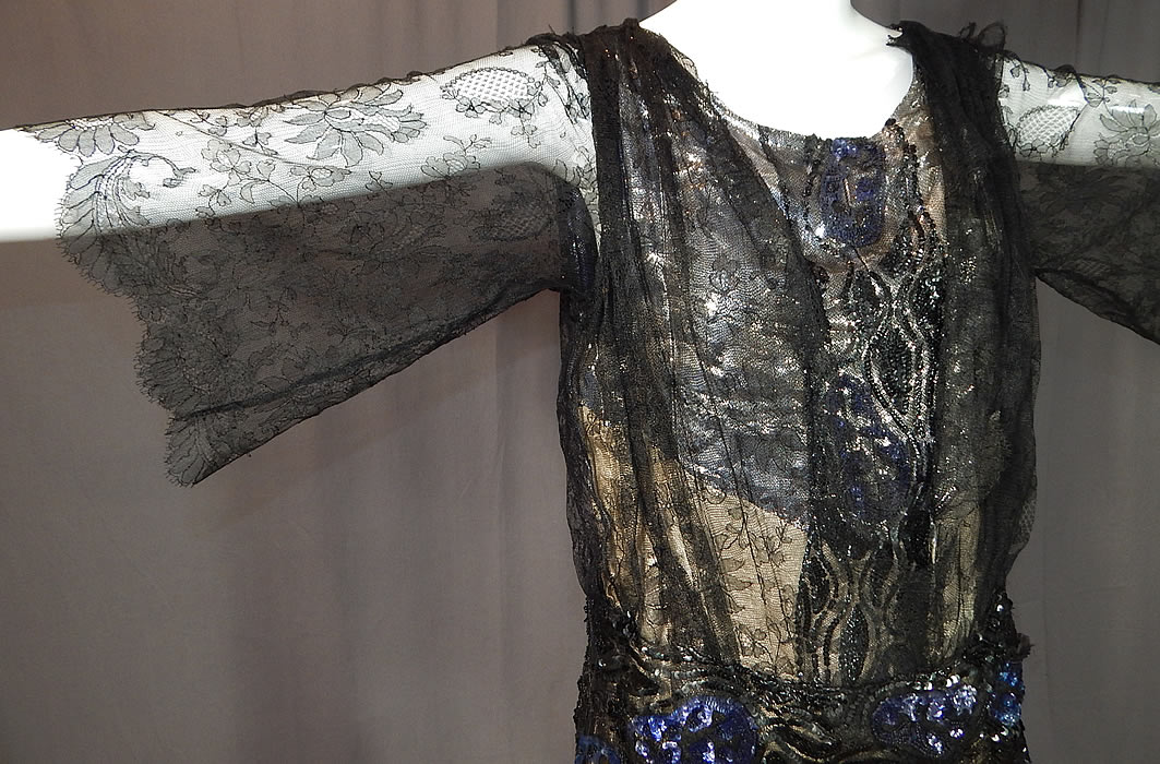 Vintage Art Deco Silver Lam&eacute; Lame Black Chantilly Lace Sequin Beaded Gown
There are black and blue iridescent sequin beading done in an Art Deco design down the front and around the waist. 