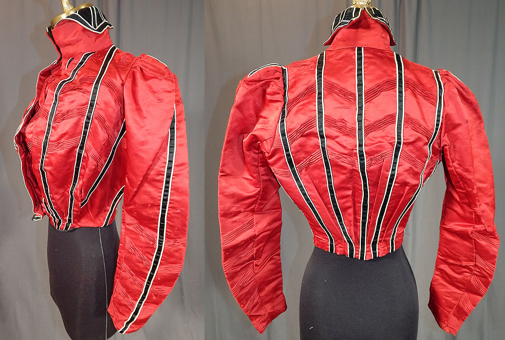 Victorian Red Silk Black & White Striped Pleated Bodice Blouse
This beautiful bodice blouse has a high neck band fold over collar, gathered shoulders, long full tapered sleeves coming to a point at the cuffs, a fitted waistband, pouter pigeon front, hook closures with hidden inner bodice down the front and is fully lined with stays, boning inside. 