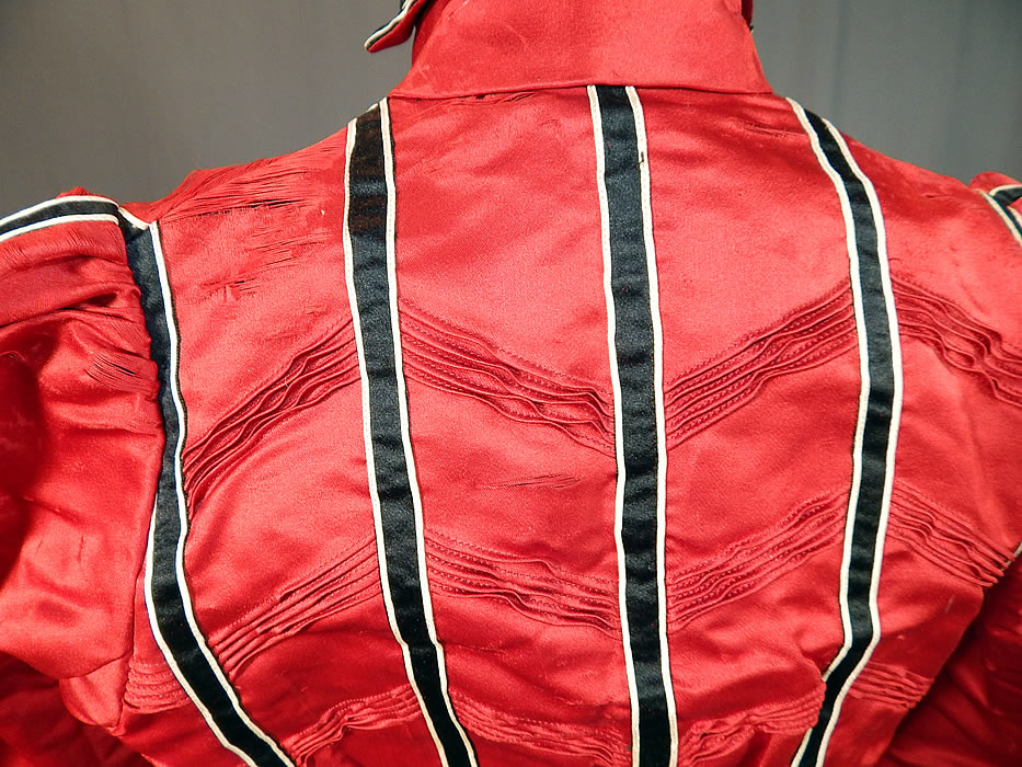 Victorian Red Silk Black & White Striped Pleated Bodice Blouse
The bodice measures 16 inches long, with a 22 inch waist, 30 inch bust, 22 inch long sleeves and 12 inch neck. It is in fair as-is condition, with several small frayed splits in the silk scattered along the shoulders and sleeves (see close-up). This is truly a wonderful piece of Victoriana textile art which would be great for display or design!