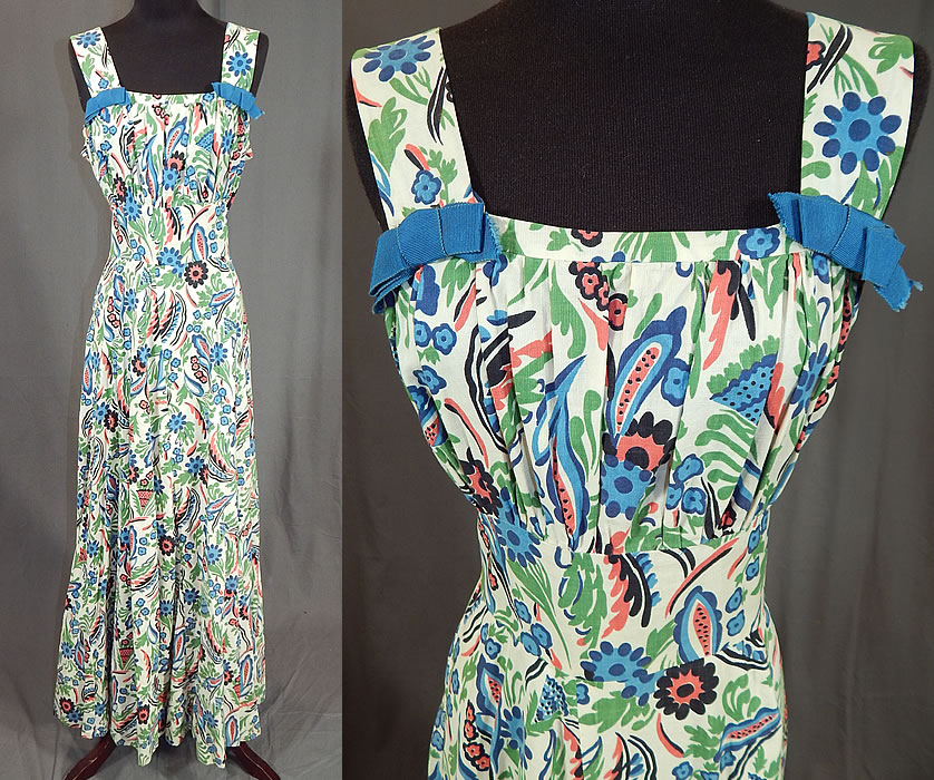 Vintage Colorful Cotton Floral Leaf Print Maxi Dress & Cropped Bolero Jacket
This stunning summer sun dress has a long floor length maxi style with full skirt, shoulder straps with blue ribbon bow trim accents, squared necklines, a fitted waist, side snap, hook closures and is unlined. The dress measures 58 inches long, with a 30 inch waist and 36 inch bust. 