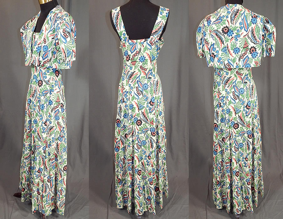 Vintage Colorful Cotton Floral Leaf Print Maxi Dress & Cropped Bolero Jacket
There is a matching fabric short cropped bolero style jacket, with gathered shoulders, short puffy sleeves, an open front with no closure and is unlined. The jacket measures 13 inches long, with a 30 inch bust. It is in good condition, but has not been cleaned and one shoulder strap is safety pinned on. This is truly a wonderful piece of wearable art! 
