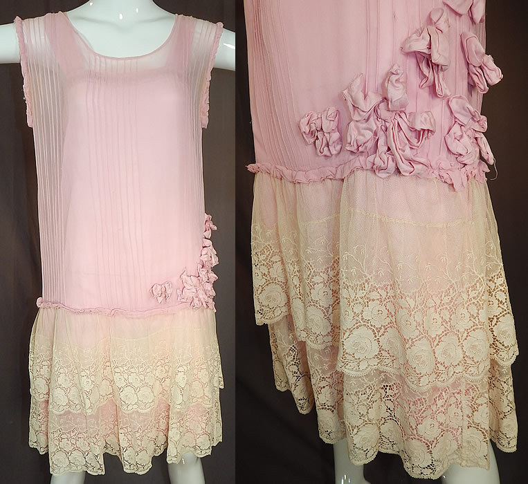Vintage Pleated Pink Silk Rosette Flowers Cream Lace Ruffle Skirt Drop Waist Dress
This vintage pleated pink silk rosette flowers cream lace ruffle skirt drop waist dress dates from the 1920s. It is made pastel pink pleated silk chiffon fabric top, with pink silk rosette flower trim sewn along the side and an off white cream color embroidered net, lace fabric floral pattern skirt.