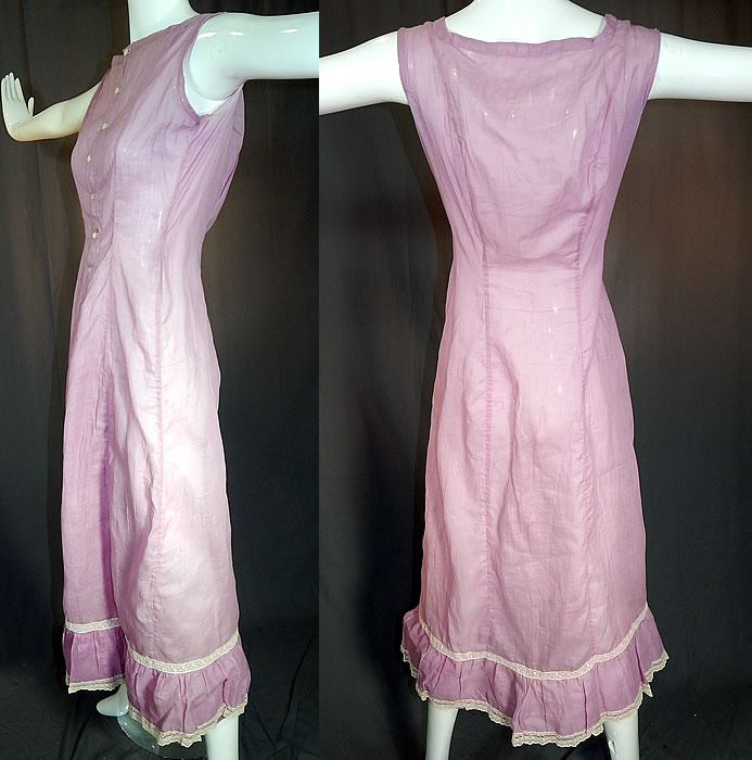 Edwardian Purple Lavender Cotton Batiste White Lace Trim Full Slip Dress
This lovely lavender and lace lingerie undergarment long full slip dress has is a long floor length, with full skirt, ruffle hemline, sleeveless, mother of pearl button front closure and is sheer, unlined. The slip measures 51 inches long, with 40 inch hips, a 22 inch waist and 36 inch bust.