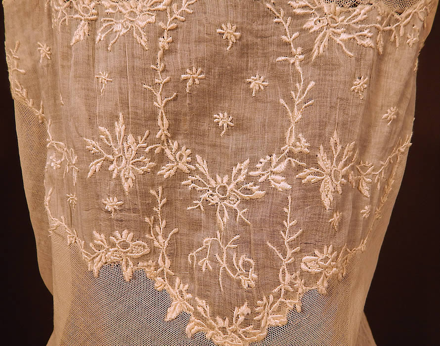 Victorian Cream Cotton Batiste Embroidery Applique Lace Lawn Dress Tea Gown
This lovely lace lawn dress tea gown is a long floor length with a high empire waist, draping sash belted back, lace trim yoke neckline, gathered shoulders with 3/4 length sleeves, hook closures down the back and is fully lined with petticoat slip skirt and stays boning inside the bodice waist area. 