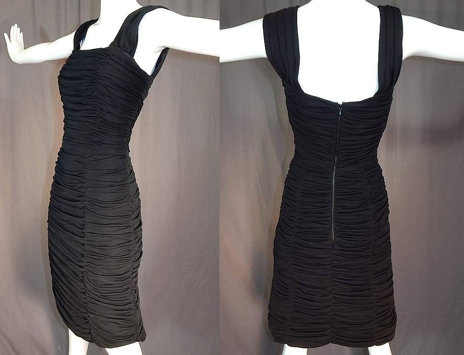 Vintage Heiress Swiss Made Black Silk Jersey Pleated Ruched Sheath Cocktail Dress
This classic little black cocktail party dress has a form fitting sexy wiggle sheath style, squared necklines, pleated shoulder straps, a mid length pencil skirt, back zipper closure and is fully lined with quality workmanship, stays boning inside the top and a net lace trim petticoat skirt. 