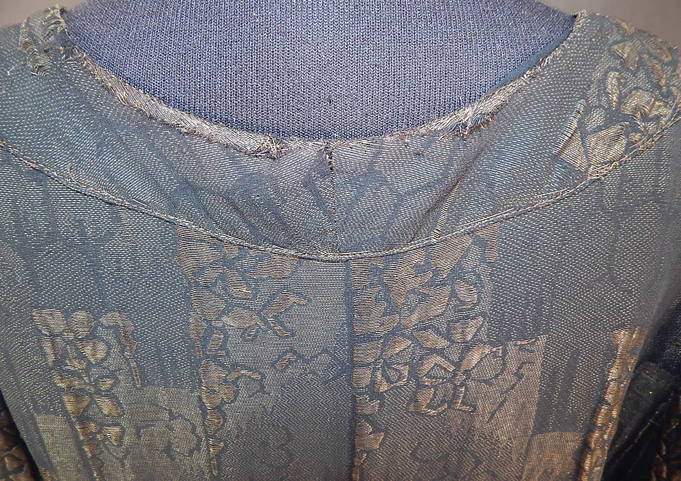 Vintage Art Deco Black Silk Gold Lam&eacute; Lame Long Flapper Coat Jacket Tassel Trim
This fabulous flapper coat jacket has a loose fitting long mid length style, with a V front plunging neckline, long sleeves, single snap closure front and is fully lined in a black silk fabric inside. The coat measures 35 inches long, with a 40 inch bust, 36 inch waist and 21 inch long sleeves. It is in good condition, with only some slight fraying along the back neck (see close-up). This is truly a wonderful piece of wearable Art Deco textile art! 