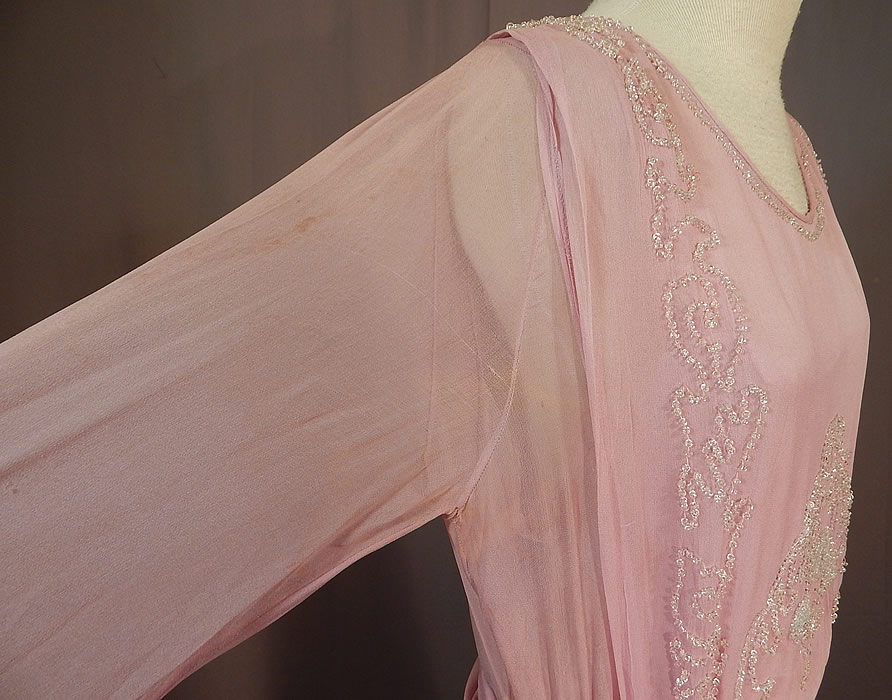 Edwardian Lilac Silk Chiffon Crystal Beaded Belted Evening Gown Dress
It is in good as-is condition, missing one beaded tassel end off the belt, with some small stains along the shoulders sleeves, faint underarm stains, slight fade discoloration and fraying along the bottom skirt hemline (see close-ups). 
