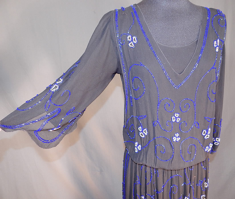 Vintage Art Deco Black Silk Pink & Cobalt Blue Beaded Spiral Floral Flapper Dress
This fabulous flapper dress has a layered overblouse style, with 3/4 length full sleeves, scalloped edging, side and shoulder snap closures, a fitted waistband inside and is fully lined.