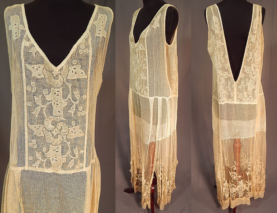 Vintage Cream Crochet Fishnet Embroidered Eyelet Lace Handkerchief Drop Waist Dress
This lovely lace loose fitting shift style chemise dress has a drop waist, handkerchief uneven, split long skirt with silk chiffon hemline, sleeveless with plunging low V necklines and is sheer, unlined. 
