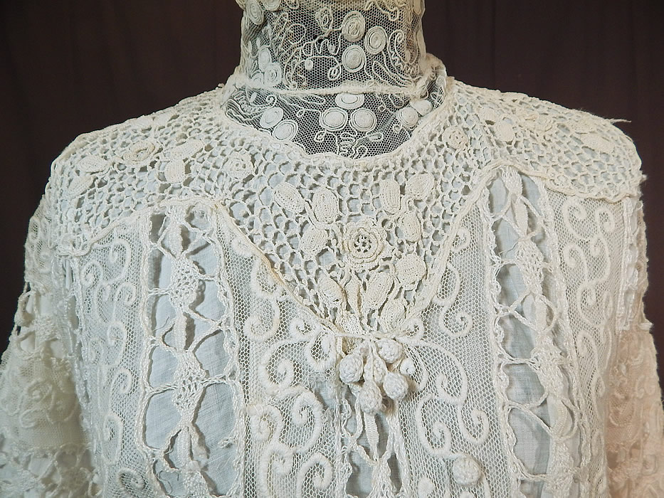Edwardian Embroidered White Net Mixed Crochet Lace Bodice Blouse
This beautiful bodice blouse has a high neck lace collar with stays inside, 3/4 length sleeves, crochet lace ball fringe trim on the front, a fitted skirted peplum waist, snap closures down the back and is fully lined in a white cotton fabric.