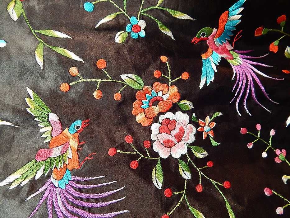 Vintage Plum Blossoms Chinese Black Silk Colorful Floral Bird Embroidered Jacket
There is a lush floral foliage and colorful bird design completely covering it. This exquisitely embroidered robe jacket has a short, loose fitting boxy style, with long full sleeves, a stiffened mandarin collar, front slit pockets, black silk toggle knotted button closure and is fully lined.