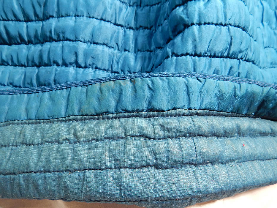 Victorian Bright Blue Silk Quilted Hand Stitched Winter Petticoat Hoop Skirt
This beautiful blue winter petticoat has a long floor length full skirt which would have had a crinoline hoop underneath for added fullness (hoop not included), a fitted waist with pleated gathers, 2 mother of pearl button closures on the back and is fully lined with a blue cotton fabric underneath. 