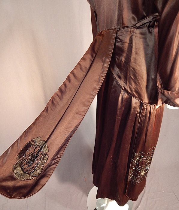 Vintage Art Deco Brown Silk Embroidered Bronze Beaded Flapper Dress Evening Gown
It is in good as-is condition, with some slight fade discoloration in areas, a few tiny pin holes on the skirt and some frayed splits on the inside top silk lining. This is truly a wonderful piece of Art Deco wearable beaded textile art!