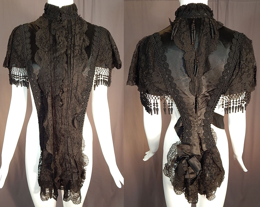 Victorian Black Silk Chantilly Lace Passementerie Mourning Mantle Pelerine Cape
This antique Victorian era black silk Chantilly lace passementerie mourning mantle pelerine cape dates from 1880. It is made of a black silk satin fabric, with black Chantilly lace, passementerie embellished trimmings, silk covered beaded ball fringe and ribbons.