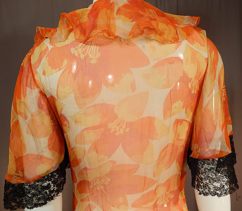 Vintage Floral Orange Blossom Print Silk Chiffon Black Lace Handkerchief Skirt Dress
This lovely luscious lace orange dress has a fitted waistband, short sleeves, a ruffle flounce collar neckline, backed in silk lining on the top only, an asymmetrical black lace handkerchief hemline skirt, no side opening closures and is sheer, unlined. 