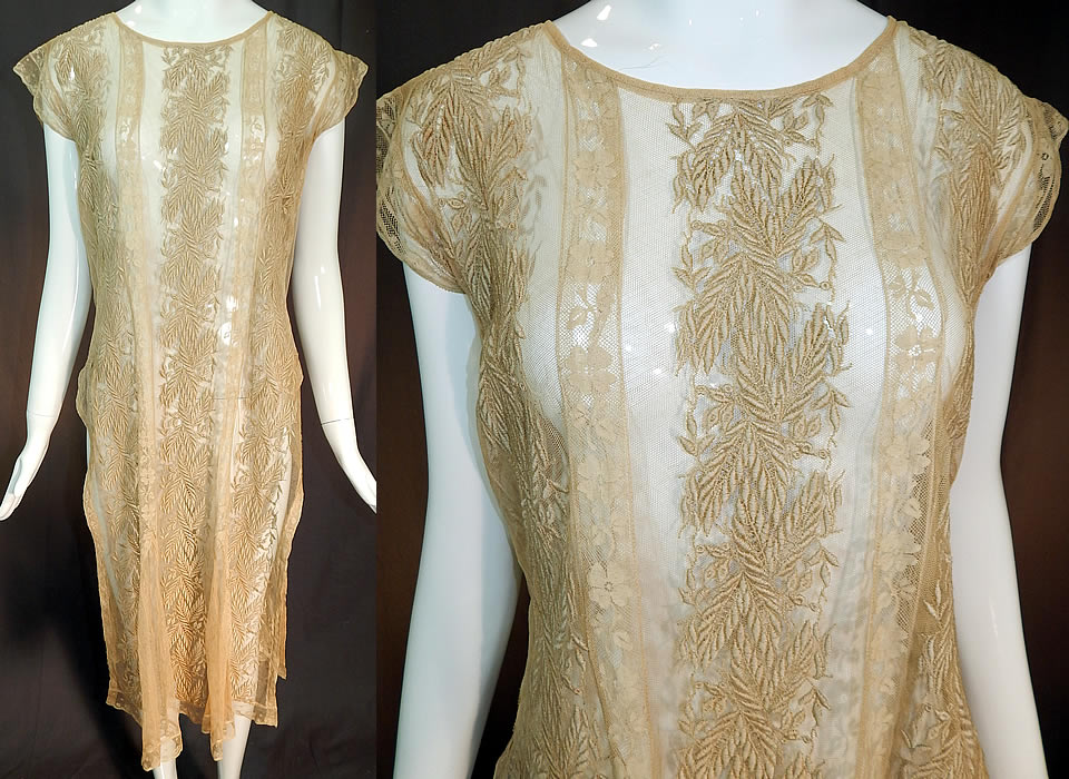 Vintage Embroidered Ecru Net Lace Tabard High Slit Chemise Shift Dress
This vintage embroidered ecru net filet lace tabard high slit chemise shift dress dates from the 1920s. It is made of an ecru cream color sheer tulle net fabric, with raised padded satin stitch embroidery work done in a wheat stalk leaf design and Valenciennes lace trim inserts with floral pattern.