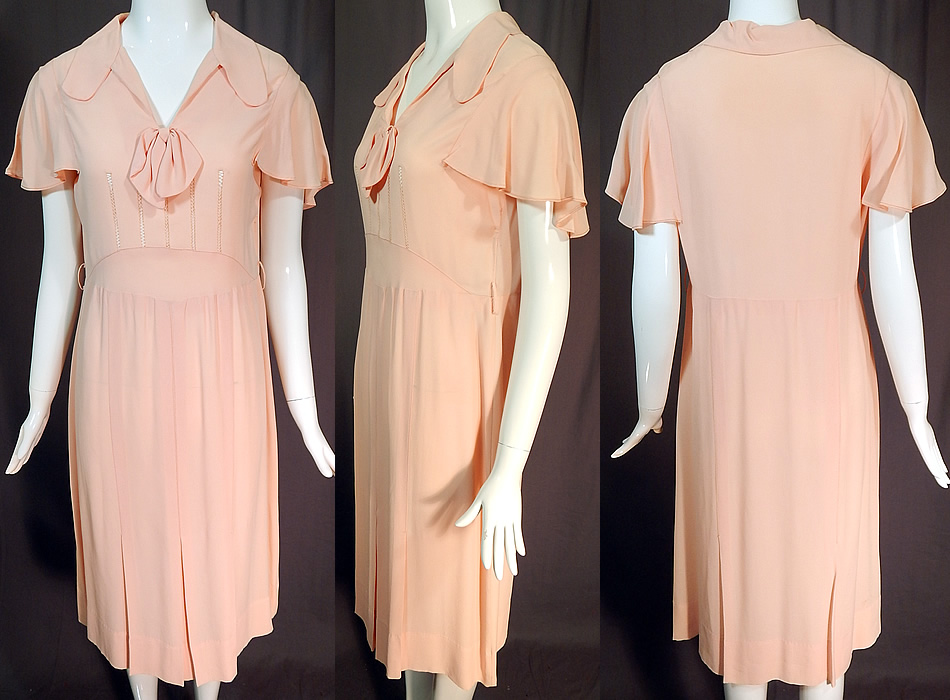 Vintage Pink Pastel Silk Crepe de Chine Drawn Work Cape Sleeve Day Dress
This vintage pink pastel silk crepe de chine drawn work cape sleeve day dress dates from the 1930s. It is made of a pink pastel silk crepe de chine fabric with drawn work details on the front top. 