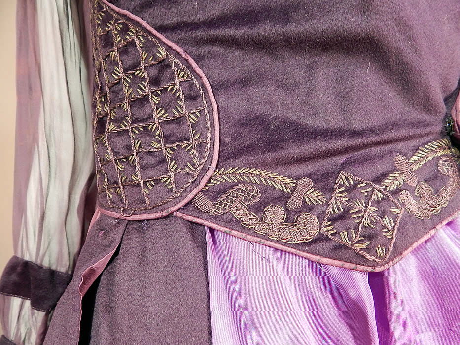 Edwardian Titanic Era Plum Purple Gold Embroidered Evening Gown Dress
This pretty purple gown has a layered, draped style, with a wrap top neckline, gold embroidered epaulettes trim shoulders, long sheer sleeves with button trim cuffs, peplum panel side drape overlay, a replaced bright purple nylon rayon taffeta fabric purple underskirt, snap closures along the front side and is lined inside the top only with hook closures down the front.